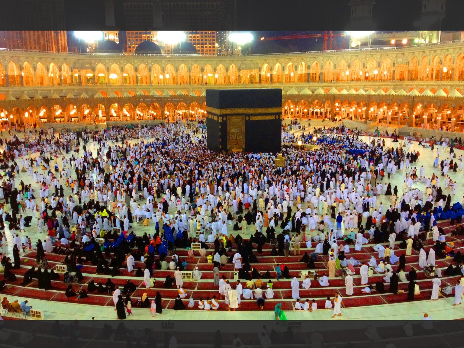 Pilgrims performing tawaf around the Kaaba at night